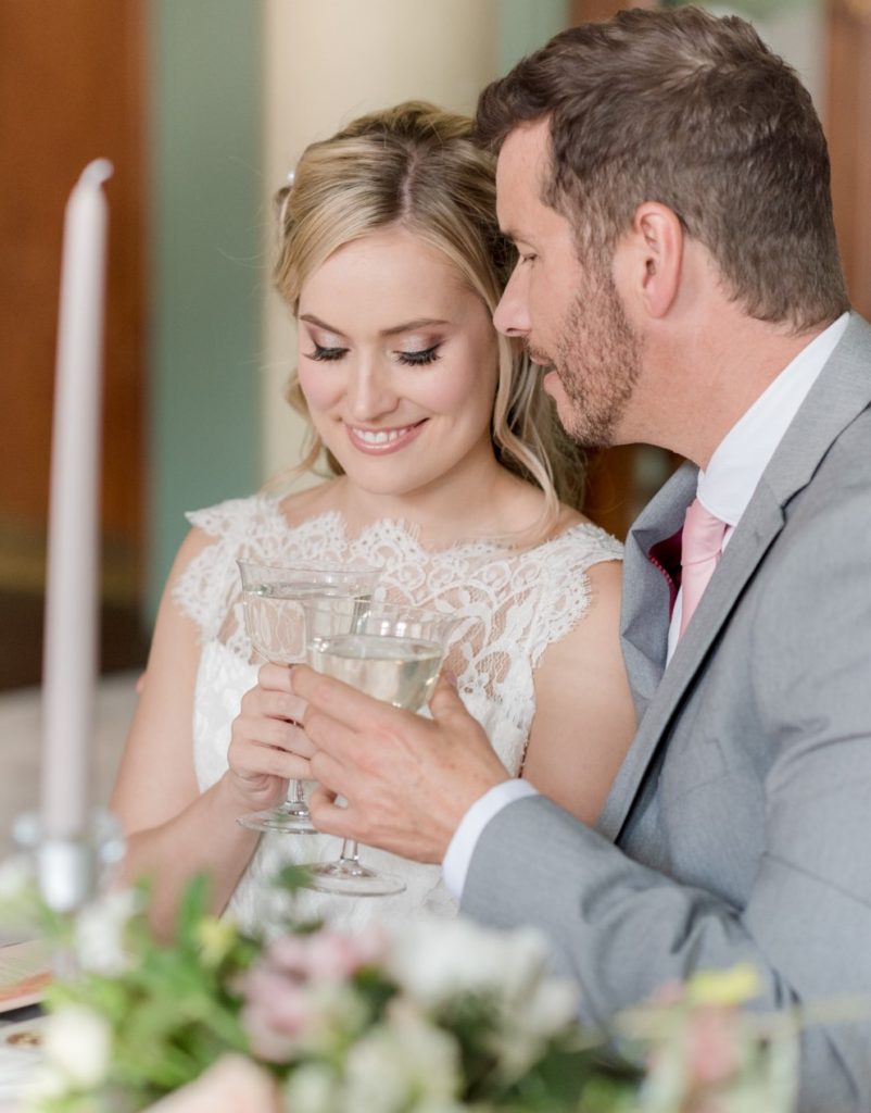 Bride and groom toasting at wedding reception