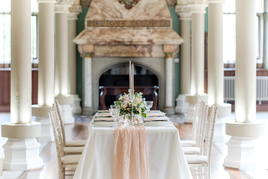 wedding reception table with silk table runner, flowers and candles