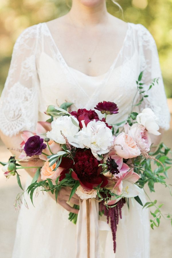 Bouquet with burgundy, dusty pink and cream roses with a burgundy ribbon