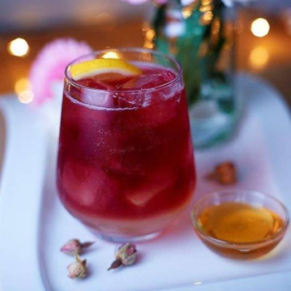 Cassis cocktail in short glass with orange garnish